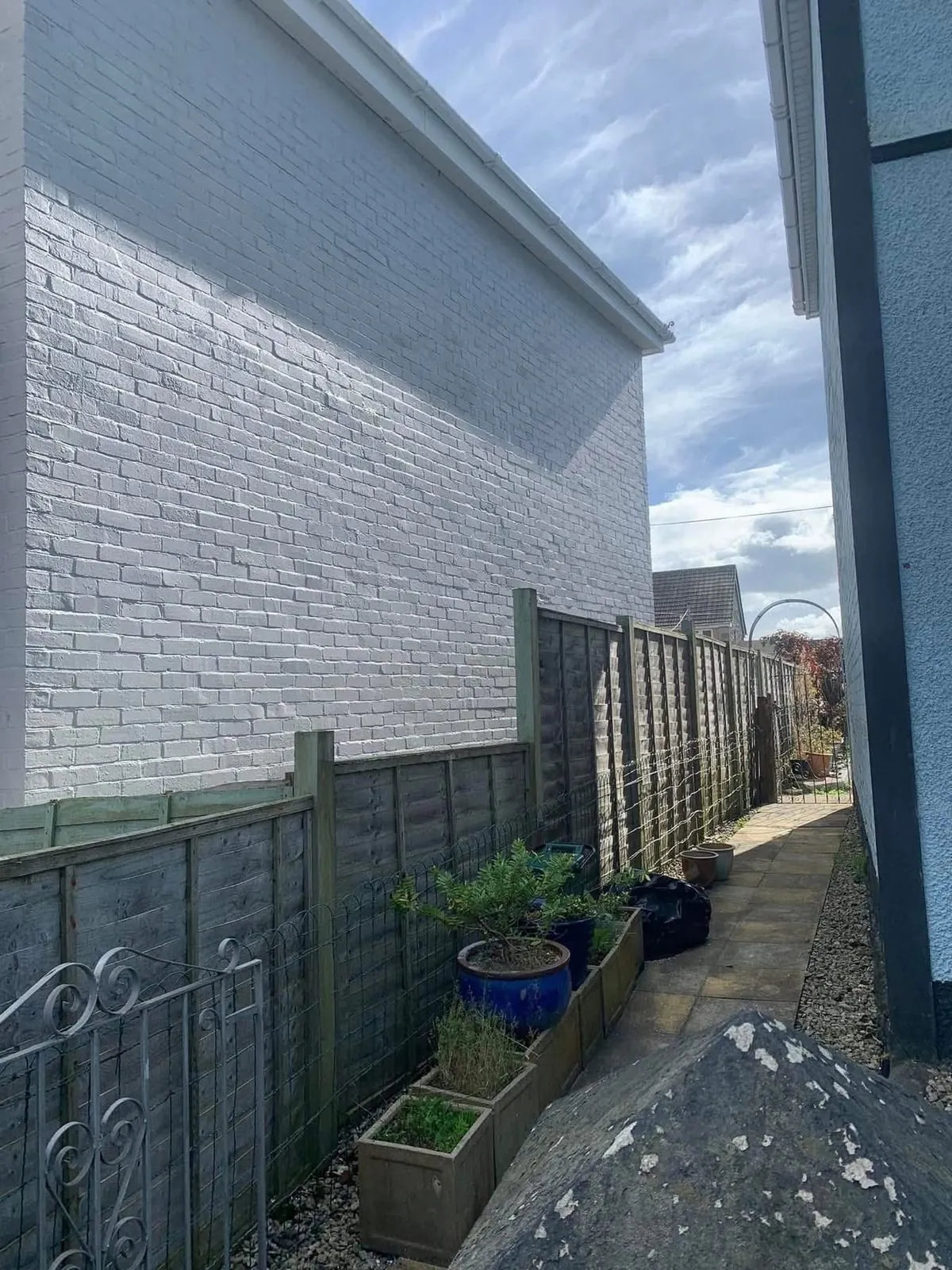 Freshly painted brick wall after preparation and masonry paint in Padstow