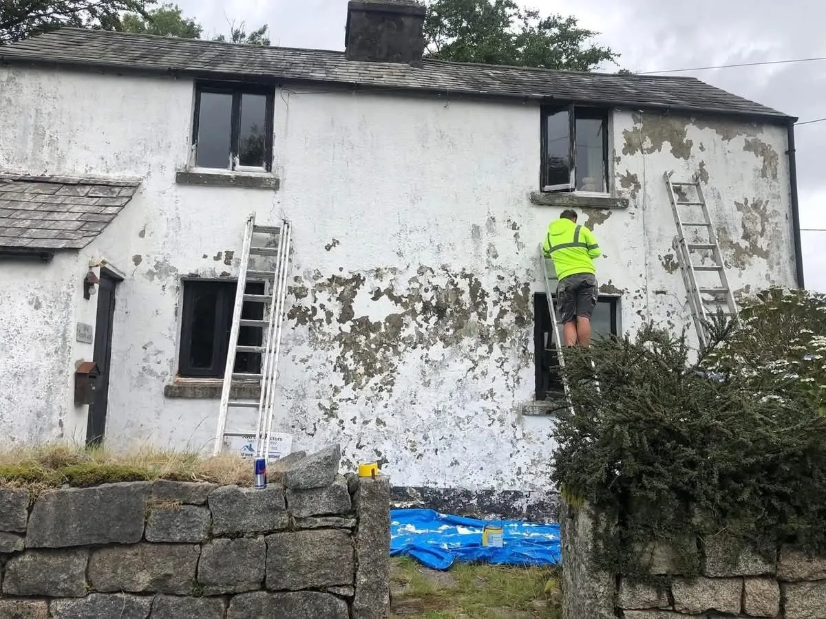 Cottage with blown, flaking render before repair in Padstow